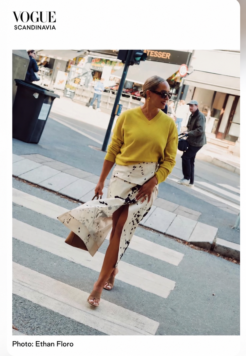 Nicole Reed pictured in Vogue Scandinavia wearing a yellow knit and patterned skirt. Photograph by Ethan Floro.